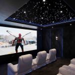 Fibre optic lighting in a luxury home cinema with star ceiling and recliner seating.