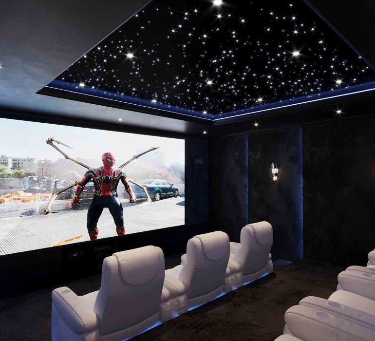 Fibre optic lighting in a luxury home cinema with star ceiling and recliner seating.