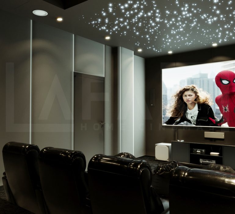 Luxury private home cinema in Dubai featuring plush recliner seats, ambient LED lighting, acoustic wall panels, and a large projector screen