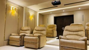 Home cinema interiors showcasing the difference between budget and luxury designs with premium seating, acoustic panels, and smart lighting.